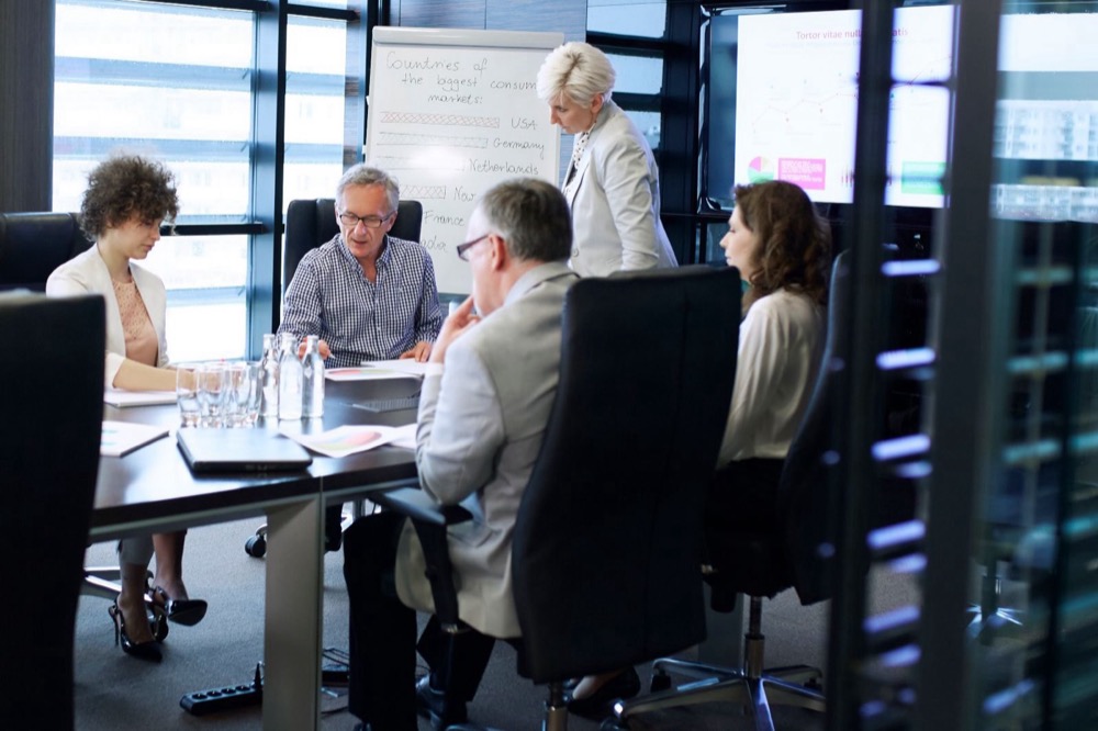 Attorneys and clients reviewing documents together around a conference table