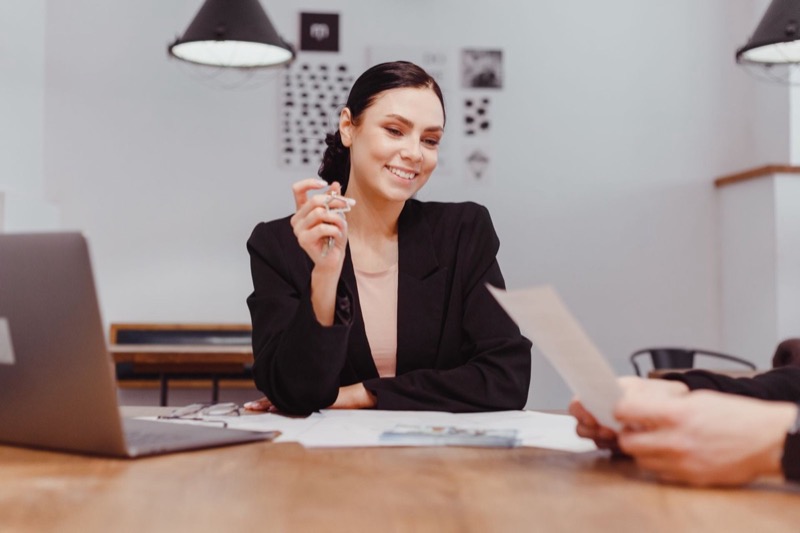 Real estate professional handing over keys after a property closing